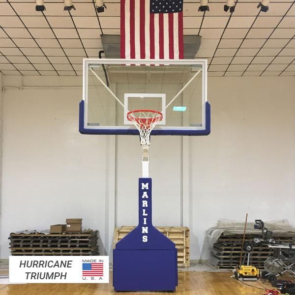 Sample of lowered portable basketball goal with tempered glass backboard and blue safety padding with print &quot;MARLINS&quot;