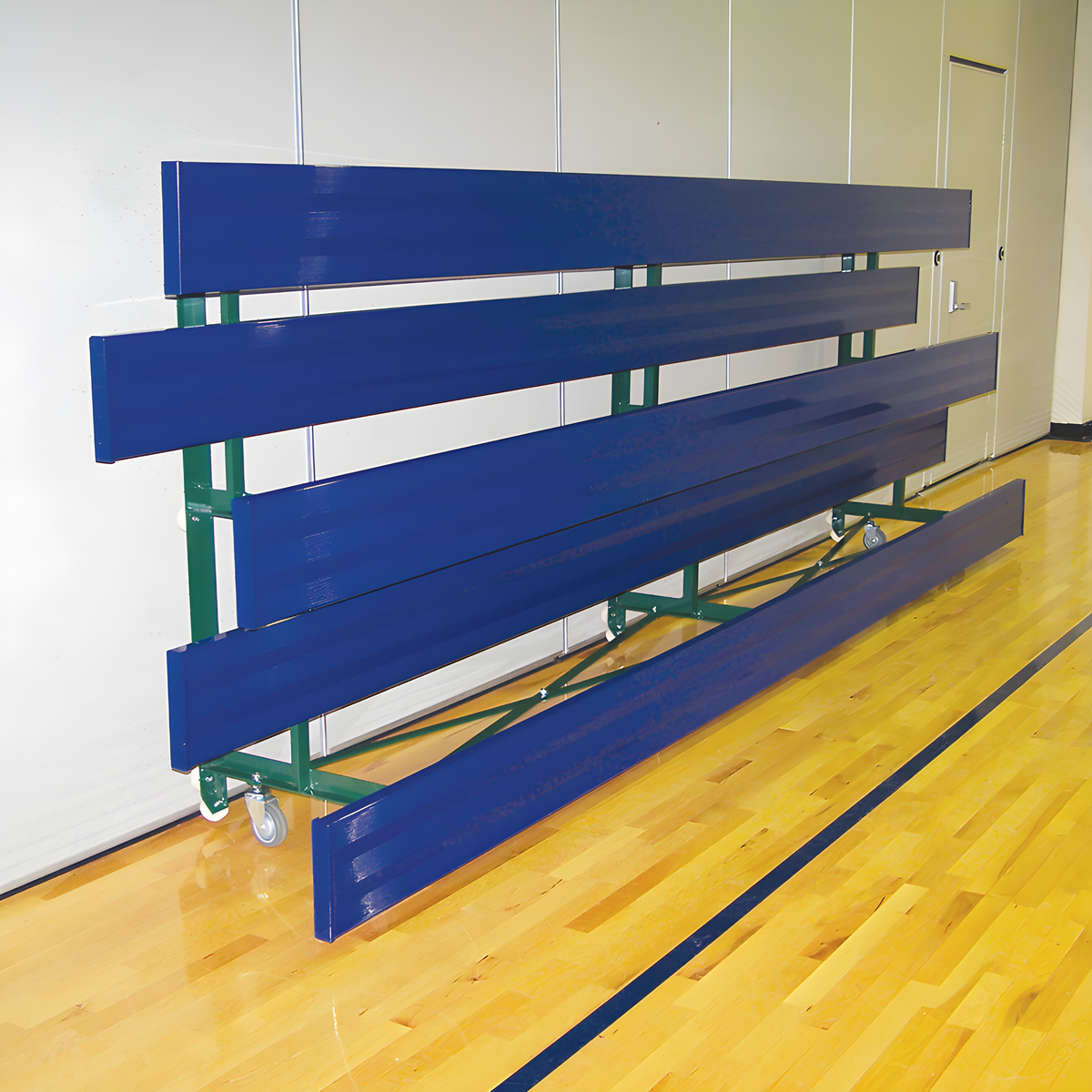 Folded blue metal bleachers on wheels in indoor gymnasium.