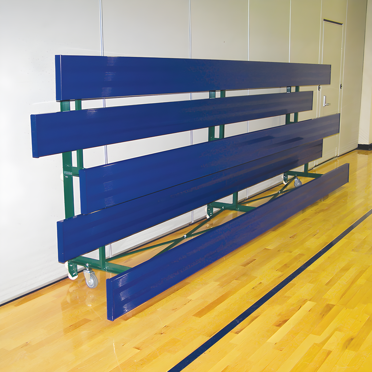 Folded indoor bleacher seats with blue panels and green frame