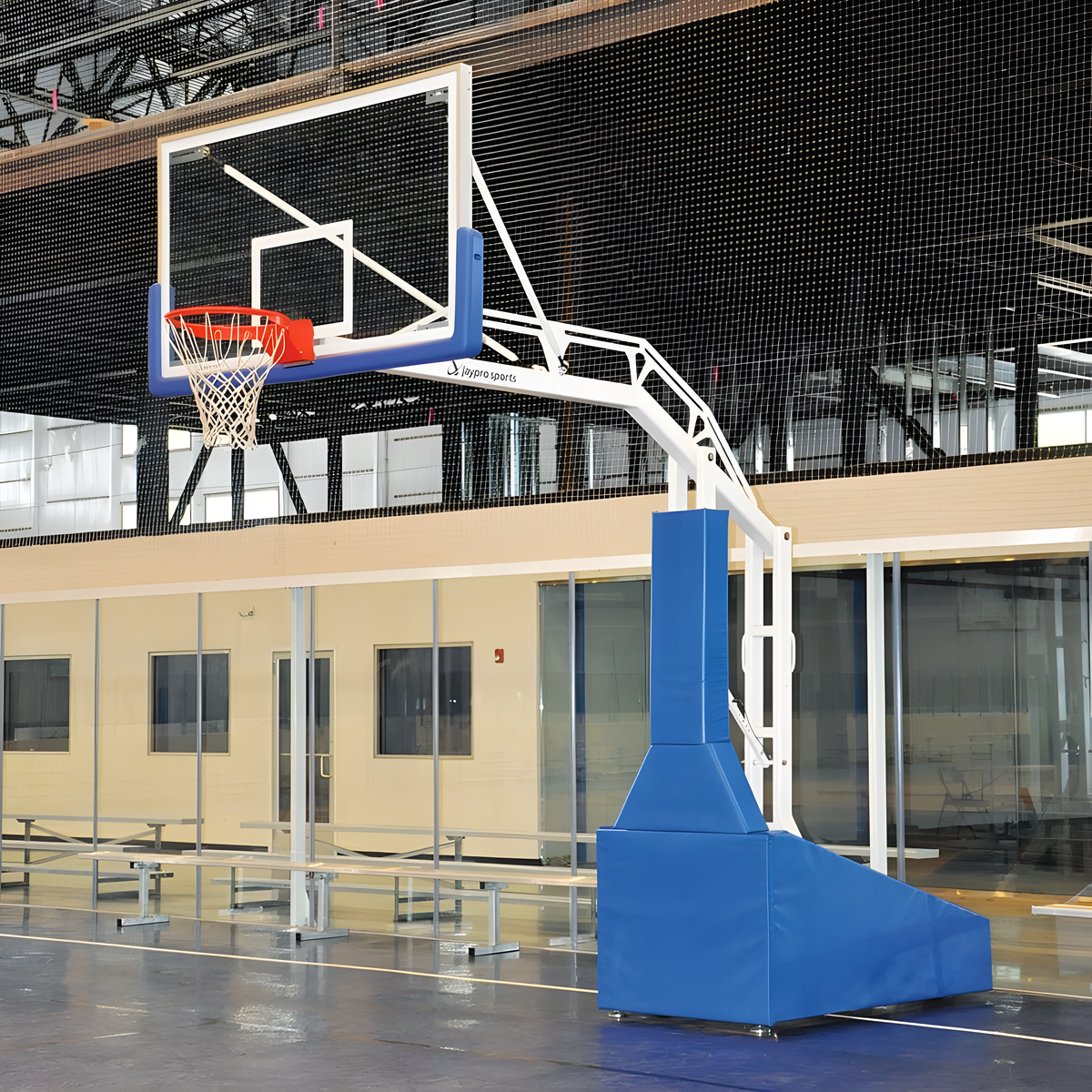 portable basketball hoop with padded base in modern sports facility.